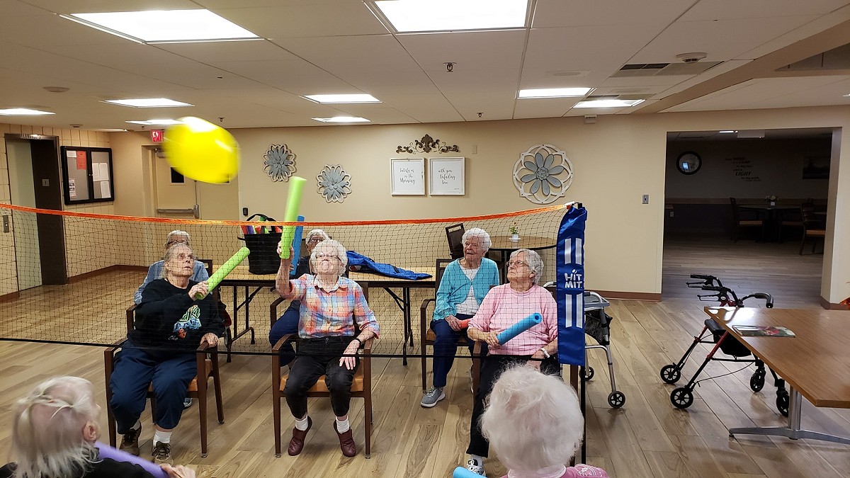 Pine Haven Giddings Avenue residents playing balloon volleyball with pool noodles